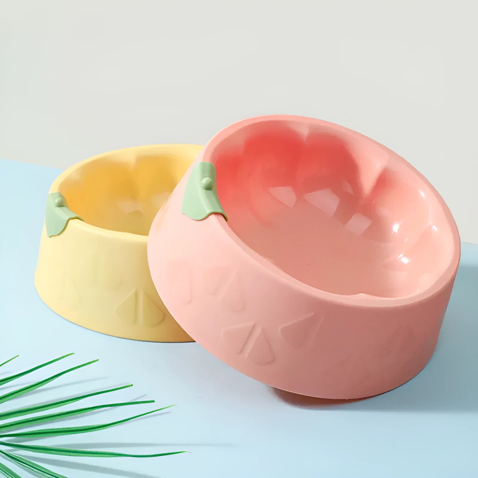 Green plastic flower-shaped double pet bowl for dog and cat food and water.