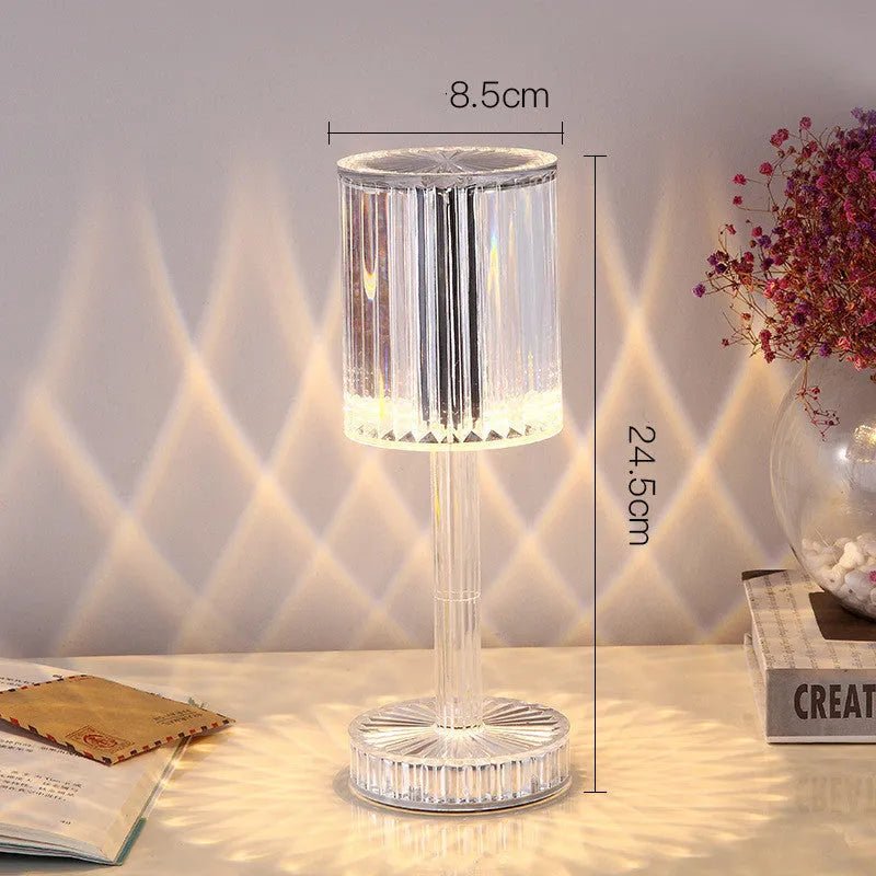 Modern crystal table lamp with a diamond-faceted shade on a metal stand, showing amber colour option.