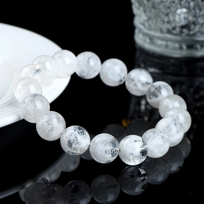 Women's crystal bracelet with round snowflake beads and a traditional Ruyi charm.