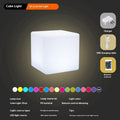 A modern square white LED cube light functioning as a waterproof stool for outdoor gardens.