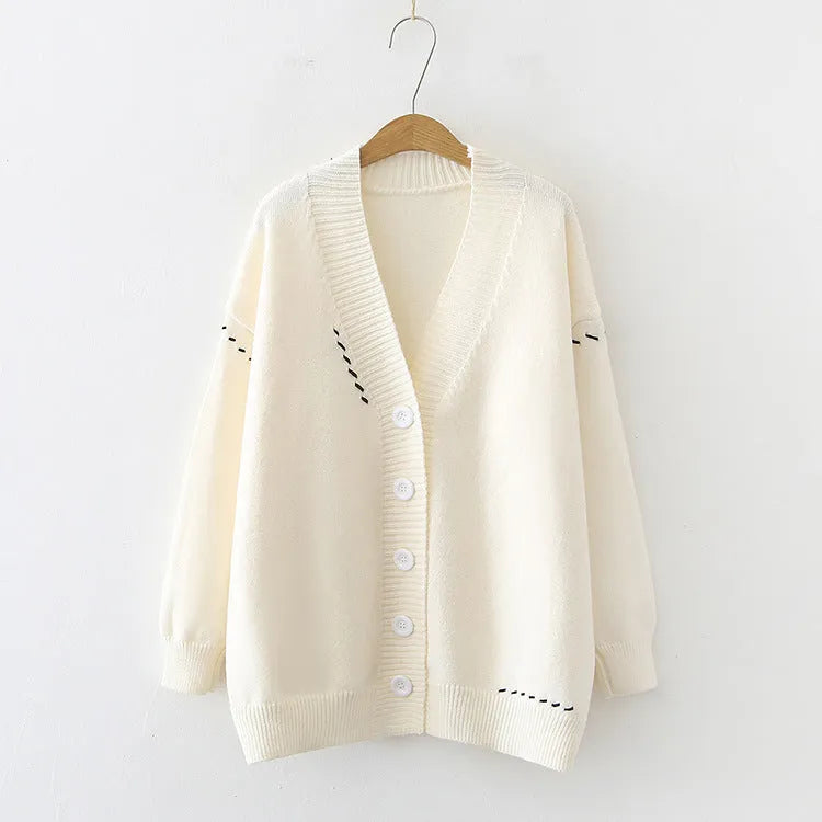 Loose fit black knitted cardigan coat with long sleeves, shown open as a casual layer.