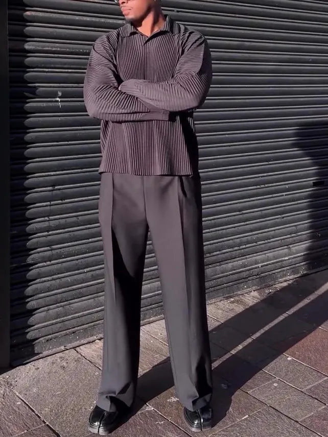 Black men's long-sleeved casual top with pleated detail on the sleeves.