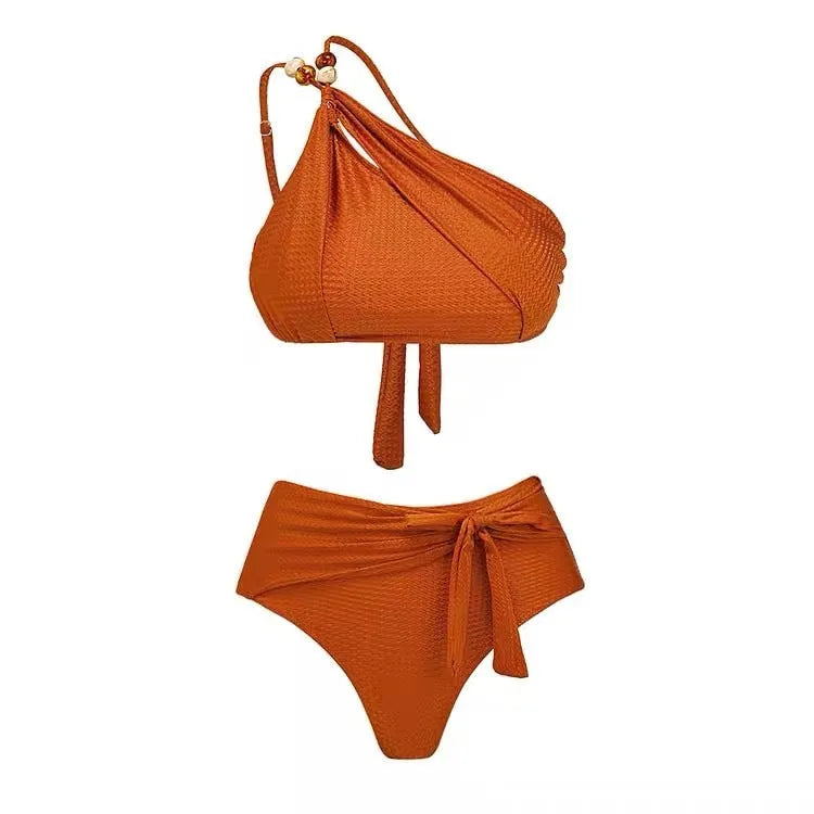 Women's brown high waist bikini with a sheer chiffon dress overlay attached.