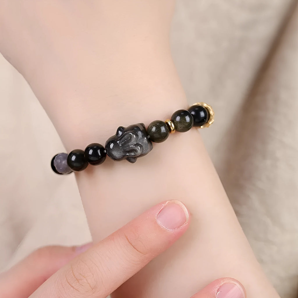 Handmade obsidian bracelet with lying rabbit charm, grey agate accents, and Yaoshi metallic elements in traditional national style