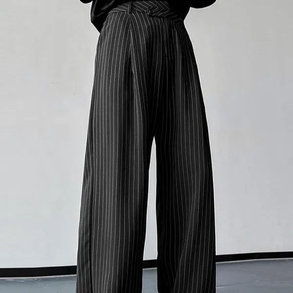 Black men's casual trousers with vertical stripes and front pleats on a hanger.