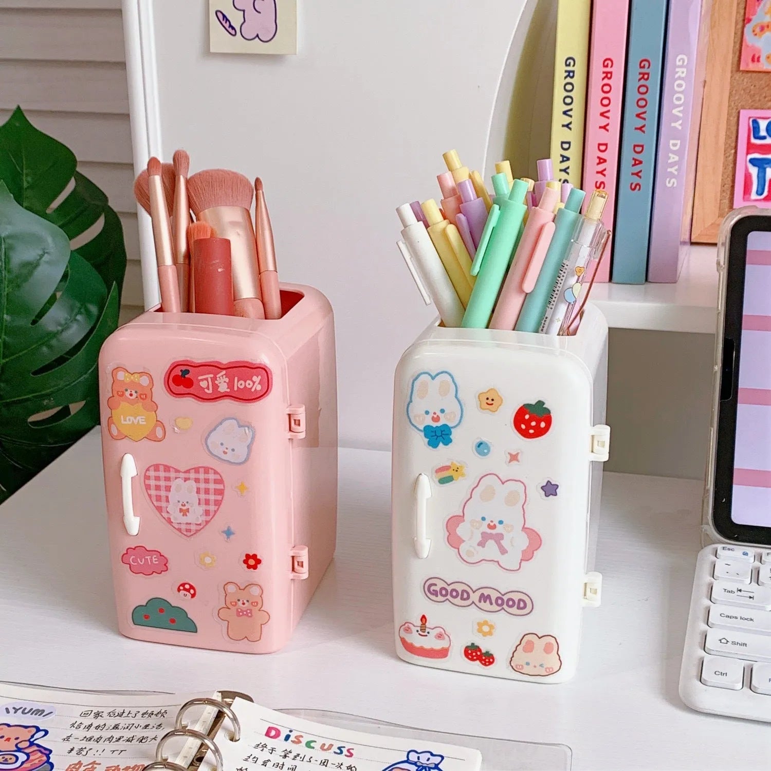 Creative refrigerator-shaped plastic pencil case in white, light blue, and pink colour options on a desk