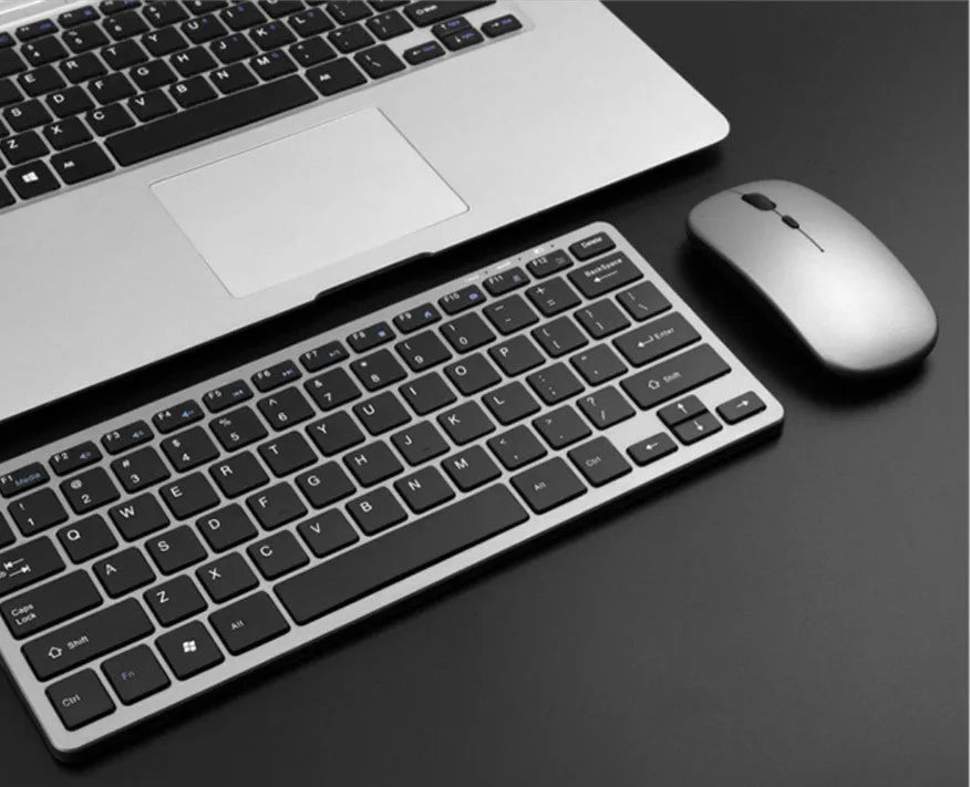 Silver wireless keyboard and mouse set with 78-key compact layout and USB charging cable