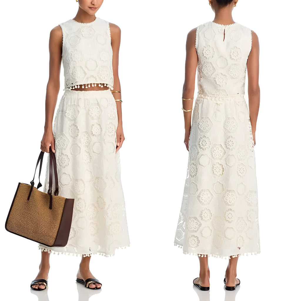 White women's sleeveless top and long skirt set with embroidery detail, laid flat.