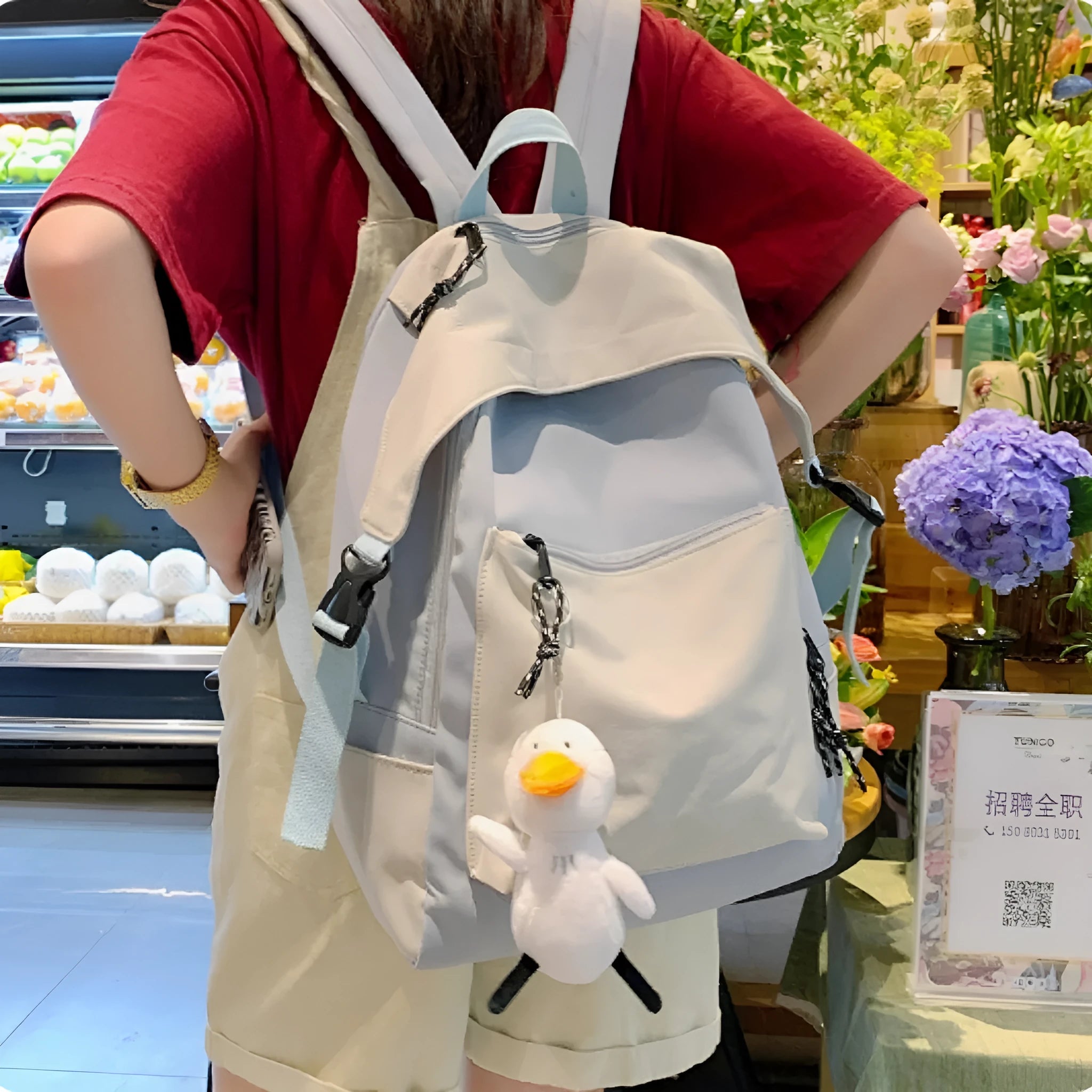 Large capacity nylon backpack in Japanese Harajuku style for female college students, vertical square shape 28x45x13cm, solid colour black, with pendant