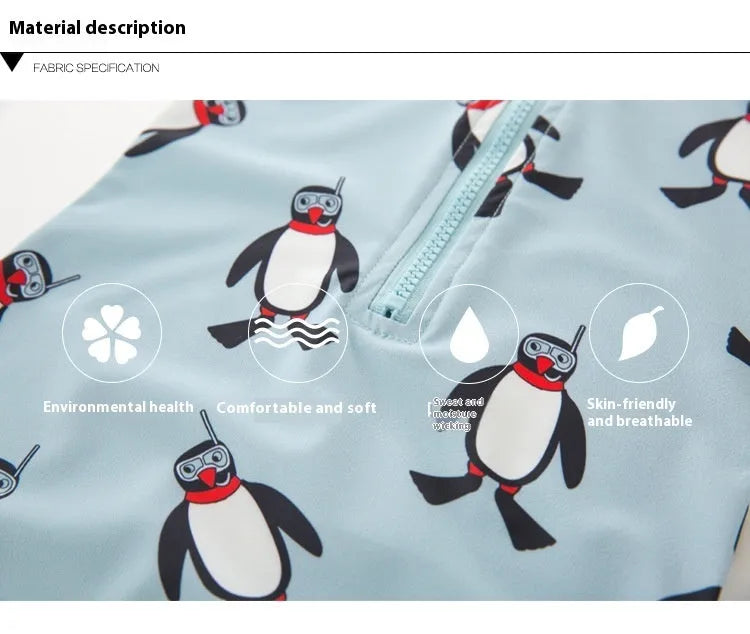 Toddler boy wearing a penguin print long sleeve one-piece swimsuit and matching swimming cap.