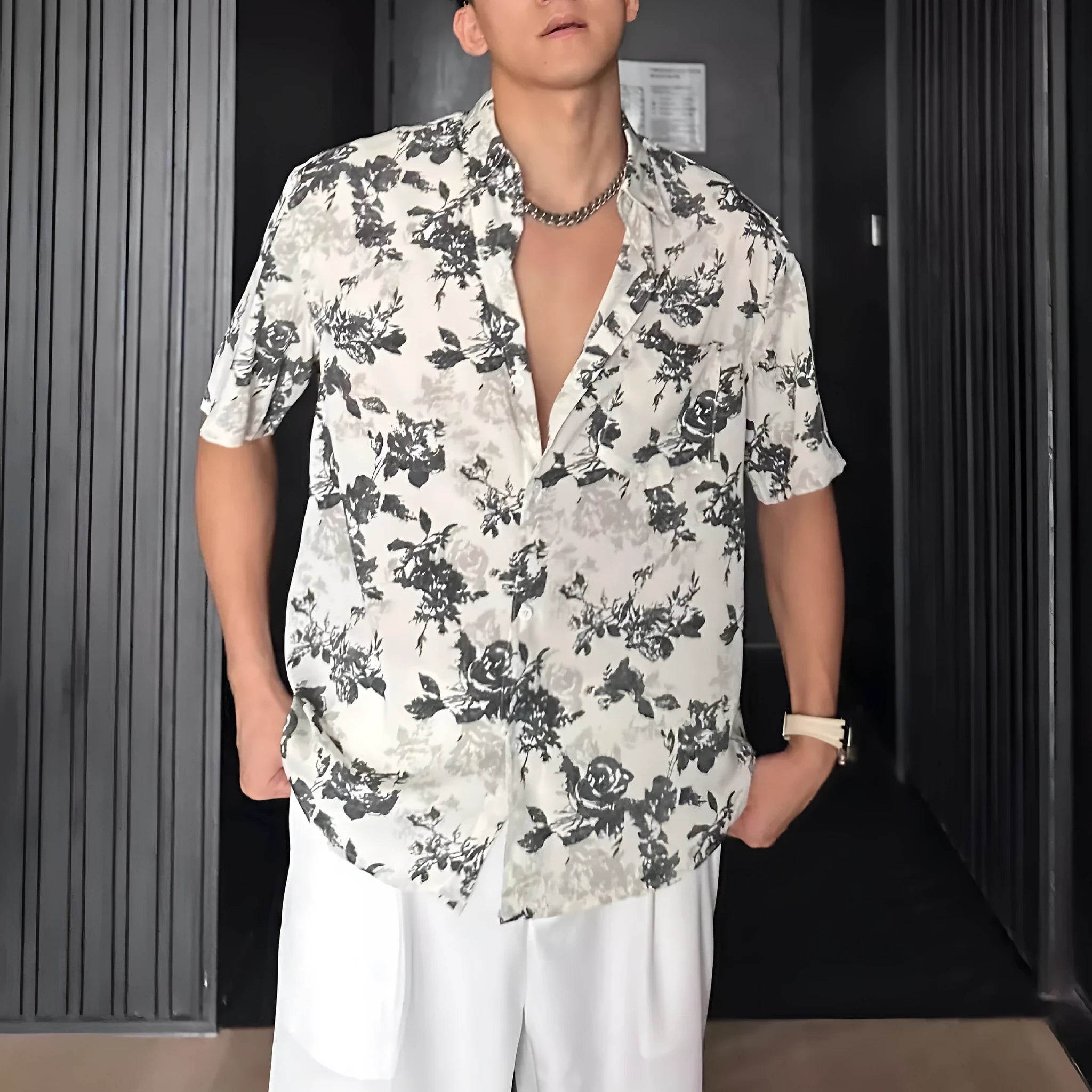 A loose-fitting, short sleeve casual shirt with a floral print, shown in a cardigan style.