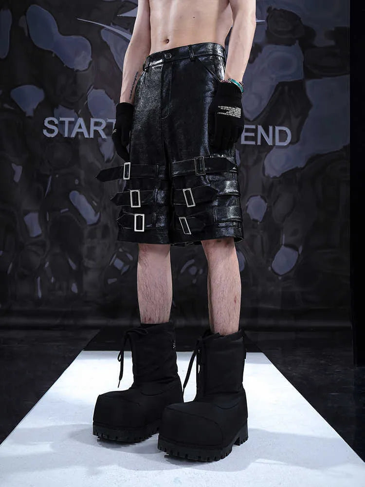 Man's black PU leather-look cropped shorts with stretch spandex material on a neutral background.