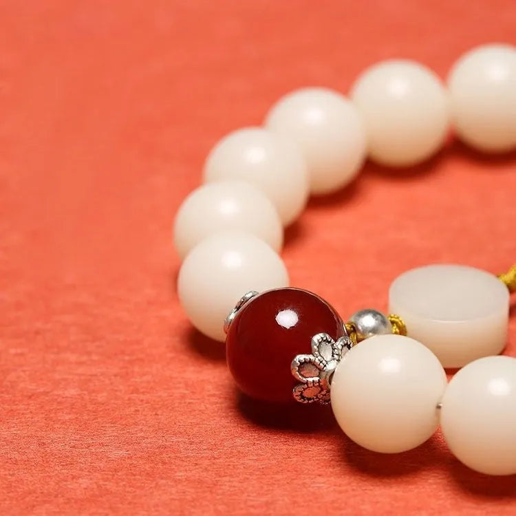 White jade bodhi bracelet with 10mm round seeds and traditional ruyi charm accents