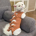 Blue lace-up back cat recovery suit for post-sterilisation care on a grey cat