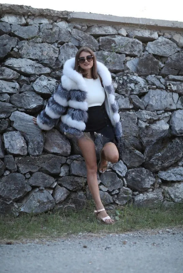 Women's loose artificial fur hooded coat in brown on a model, showing street fashion style.