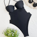 Solid black one-piece swimsuit for women on hanger showing front design