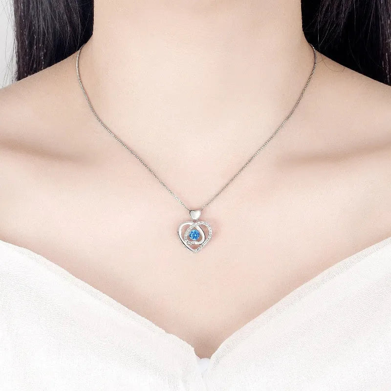 Blue diamond beating heart necklace and matching bracelet set with mixed gem inlaid pendants on geometric designs