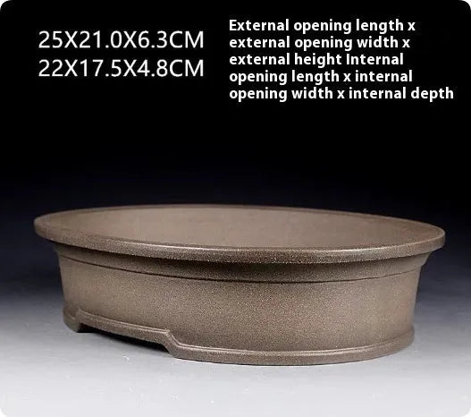 Handmade antique oval bonsai flower pot in purple sand clay, showing its 25cm length and 6.3cm depth.
