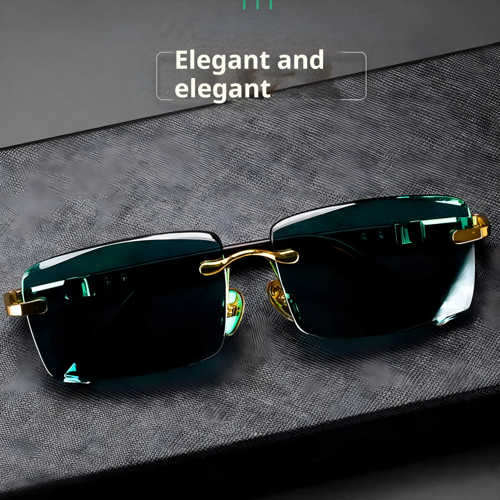 A pair of frameless sunglasses with dark green crystal lenses, shown with a hard protective case and a microfibre cleaning cloth.