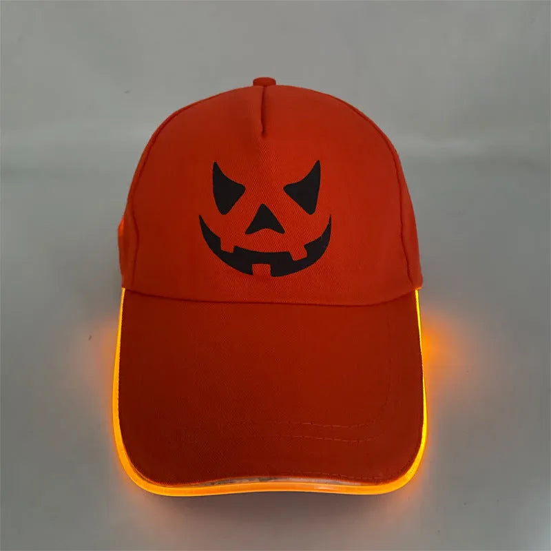 Black Halloween baseball cap with LED pumpkin smile face and yellow lights illuminated.