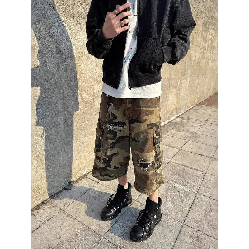 Men's loose-fit camouflage cropped jeans with ripped and patch details on a straight-leg.