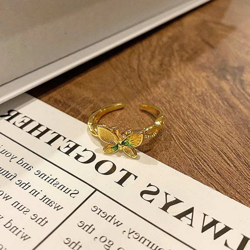 Copper butterfly women's ring with dripping oil texture and an open loop design.