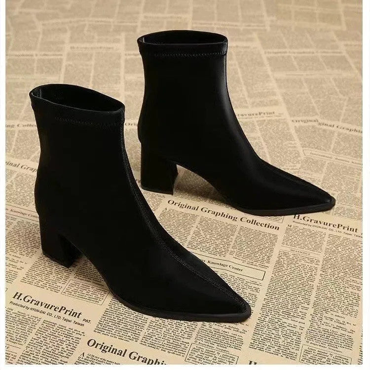 Women's khaki stretch suede pointed-toe boots with a wedge heel on a mid-calf.