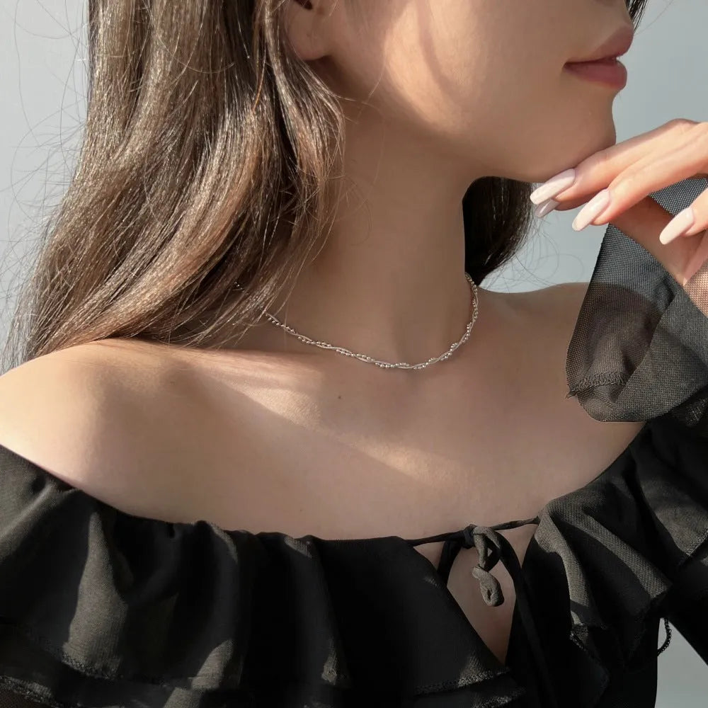 925 sterling silver geometric pendant necklace with electroplated silver finish on woman