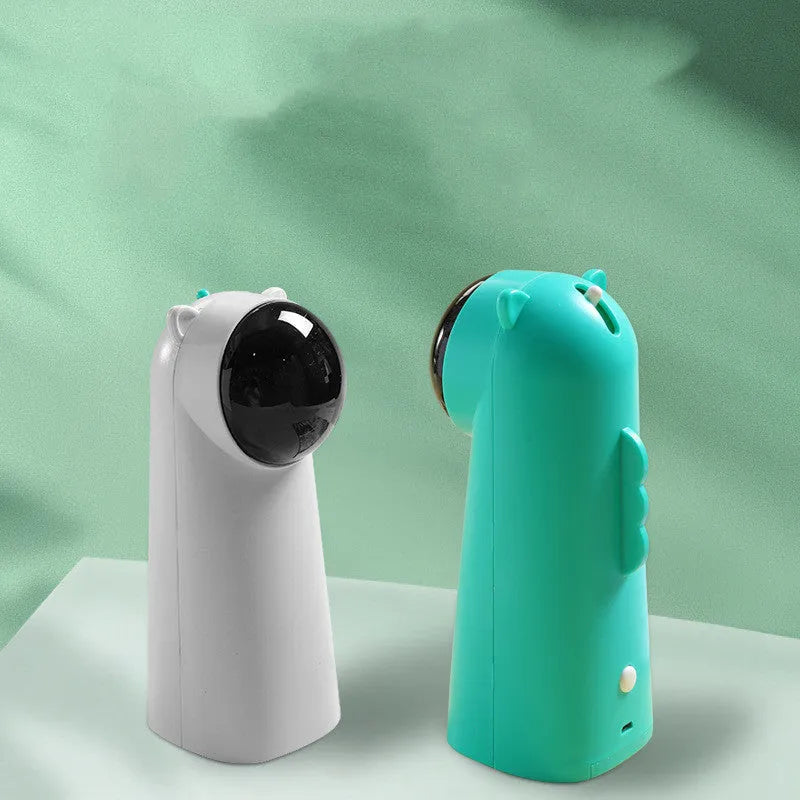 Automatic laser cat pole toy showing green with white plastic housing and LED red laser beam on floor