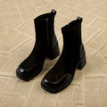 Women's black Martin boots with chunky heel and thick rubber sole, side view