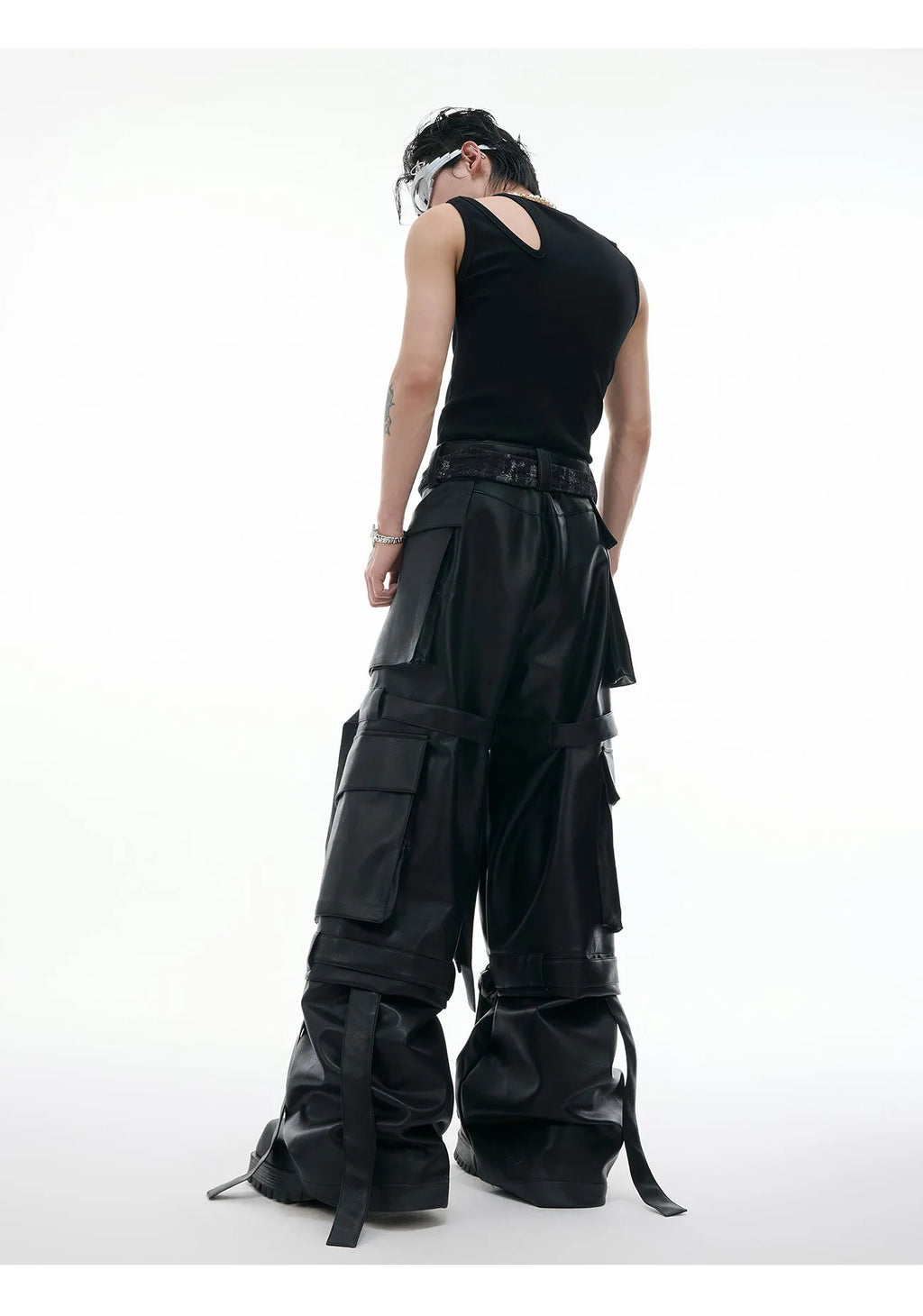 Black loose-fit men's cargo trousers with quilted panels, ribbon trim, and multiple pockets.