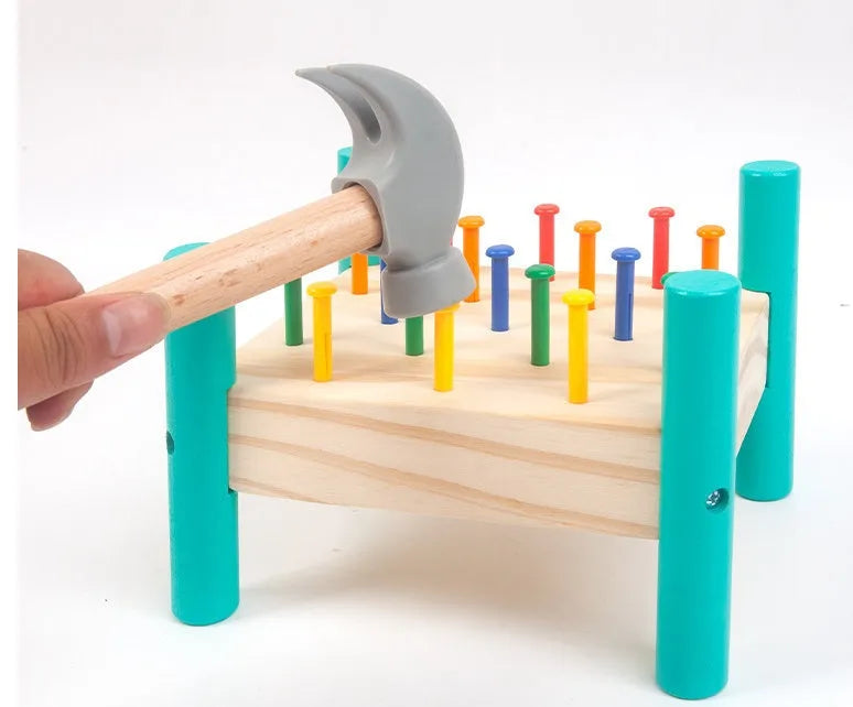 Wooden knock table with 17 colourful nails, hammer and reverse knock on khaki wood base