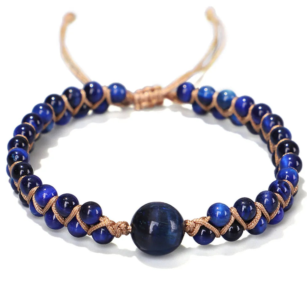 Close-up of a handmade woven bracelet featuring blue tigereye beads in a geometric pattern on a wrist.