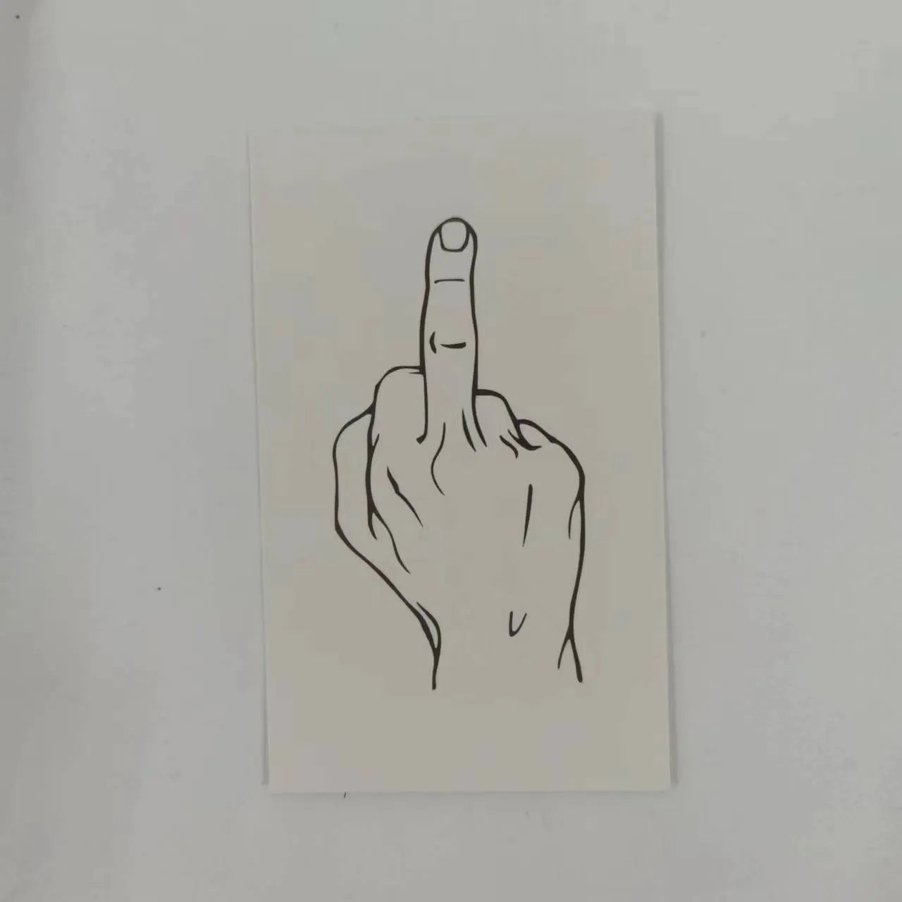 Box of paper illegal parking reminder cards featuring a printed middle finger design.