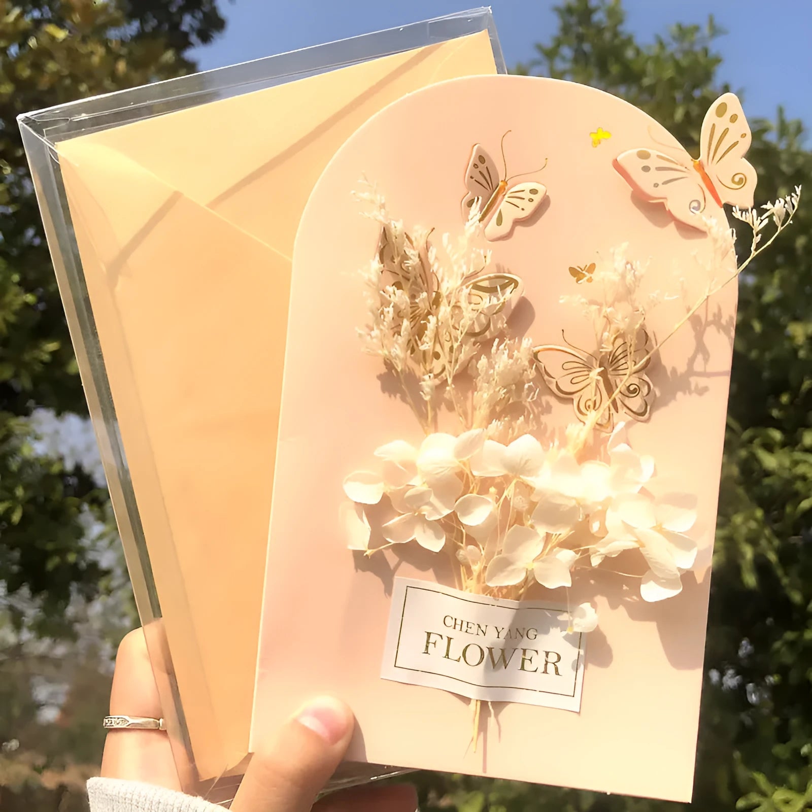 Handmade 3D boxed birthday card with butterfly shape and artificial flowers.