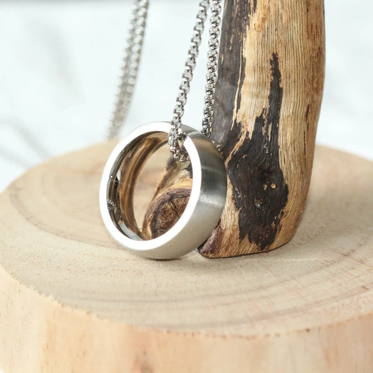 Men's silver stainless steel pearl chain necklace with titanium steel circle pendant on grey background