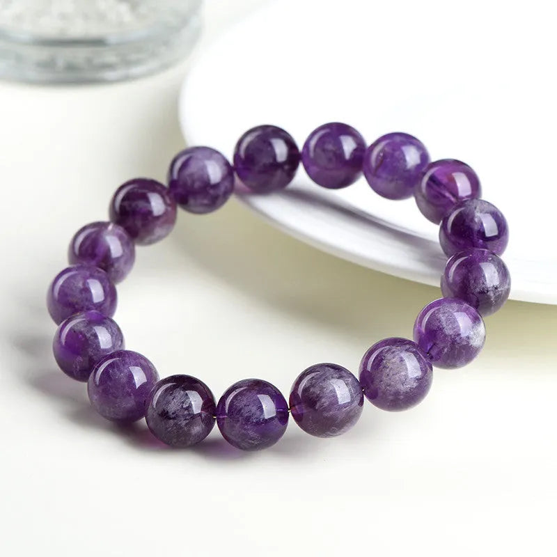 Feather amethyst crystal bracelet in Snow Mountain purple with scattered Ruyi geometry beads.