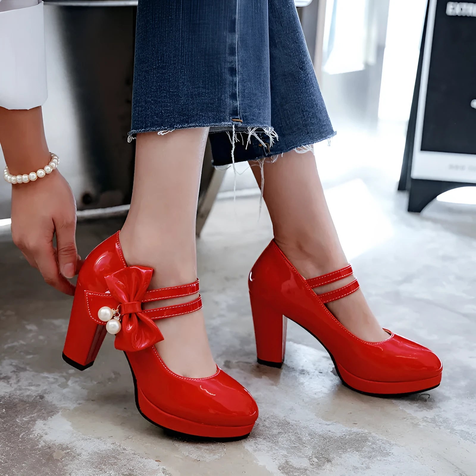 Red platform shoes with chunky heels, round toes, and buckle fastening on waterproof rubber soles