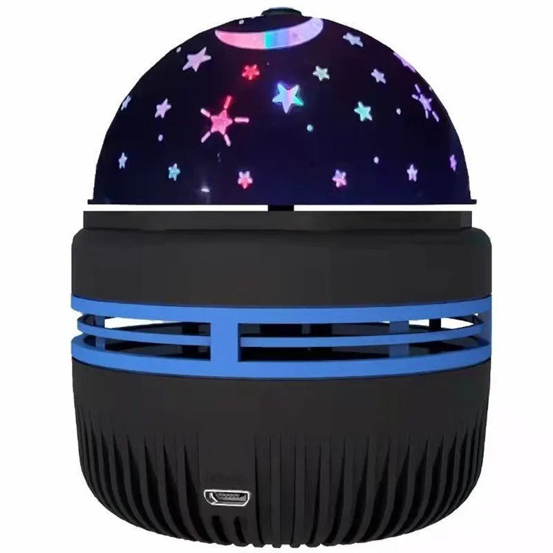 Compact white LED star projector lamp on a table, projecting galaxy light patterns on a dark wall.