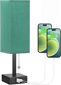 Small bedside table lamp with fabric shade and USB charging ports on a nightstand with pull chain control