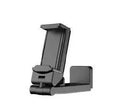 Black foldable and rotating universal mobile phone holder on a table.