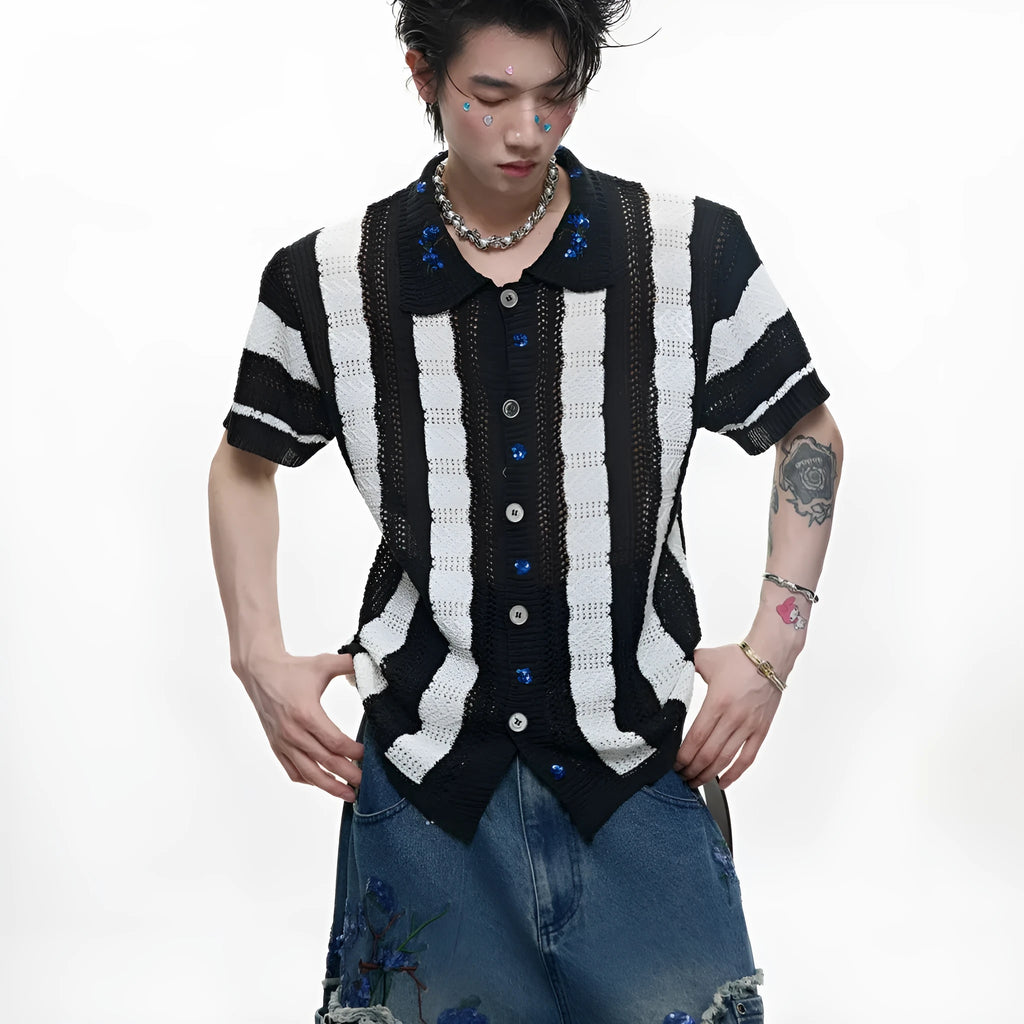 Man wearing a red and black patchwork striped knitted short-sleeved shirt with a loose fit.