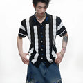 Man wearing a red and black patchwork striped knitted short-sleeved shirt with a loose fit.