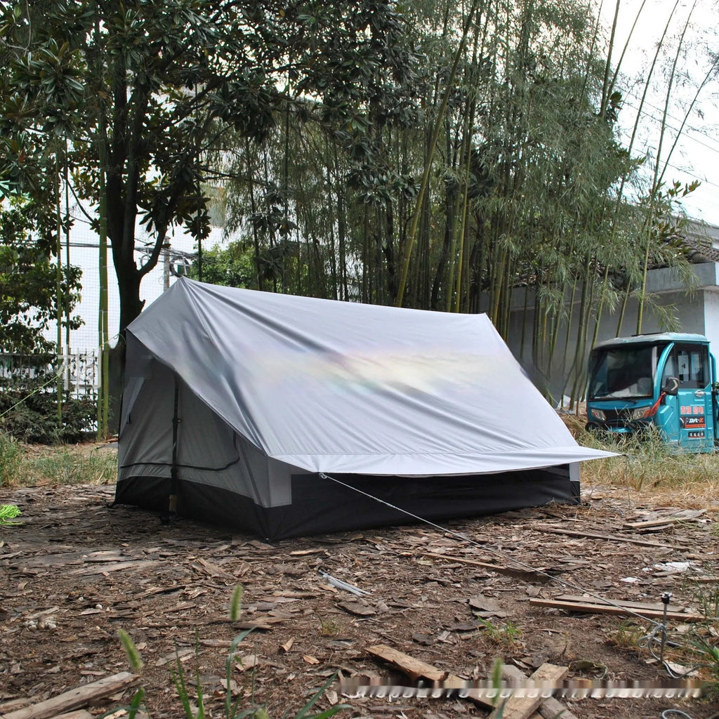 Brown A-line hiking tent pitched using trekking poles with guy ropes secured