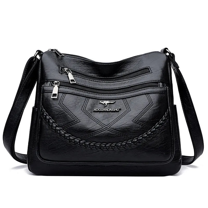 Soft leather crossbody shoulder bag in horizontal square design with zippered internal pocket