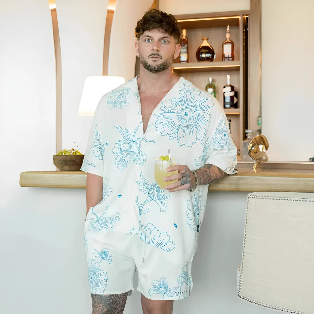 Men's loose-fit short-sleeve top with floral print in a light colour, shown on a hanger.