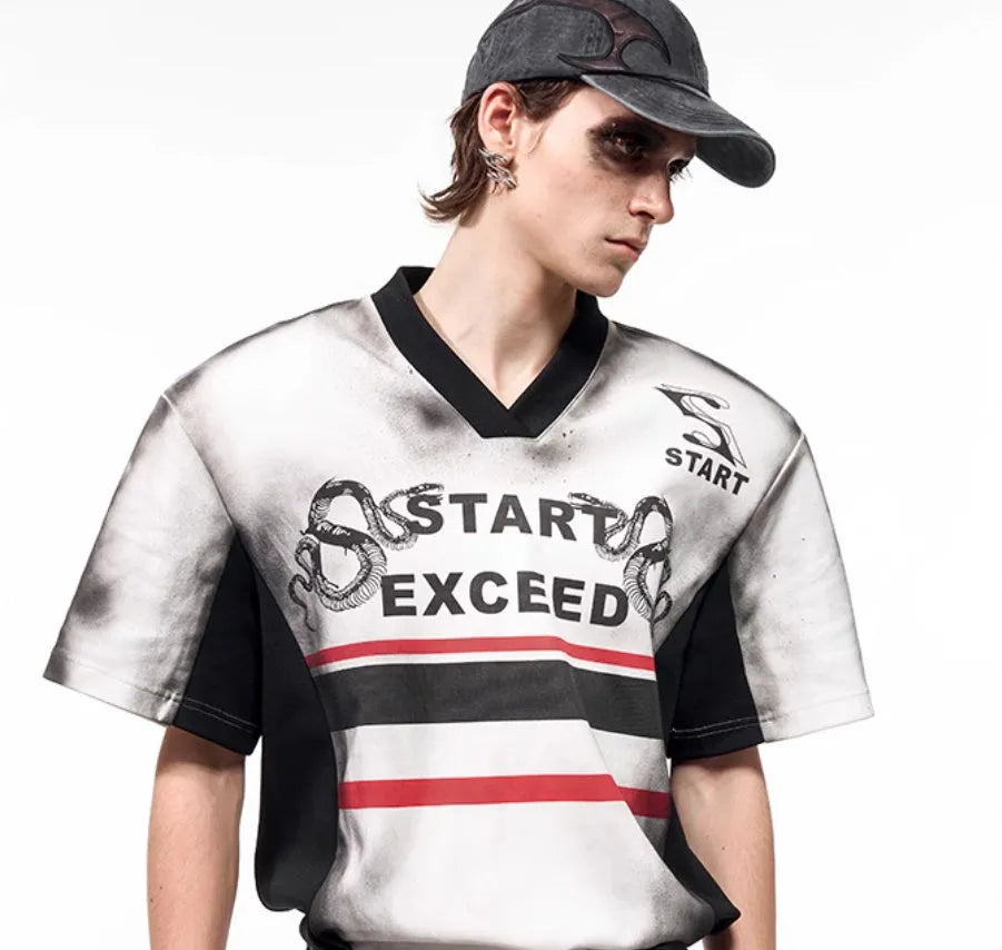 V-neck short sleeve top with snake letter pattern print and padded shoulders.