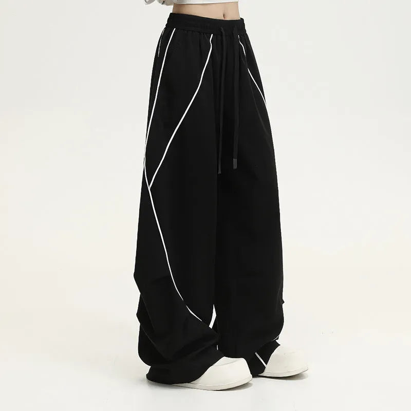 Black pleated wide-leg hip hop sports trousers with striped pattern on a mid waist.