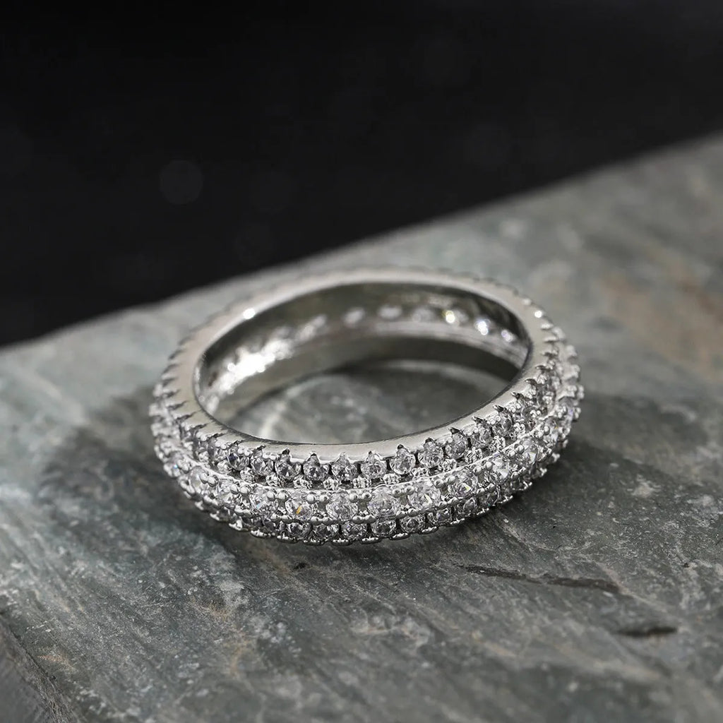 Geometric triangle ring with a zircon stone in a copper band, shown in white gold finish.