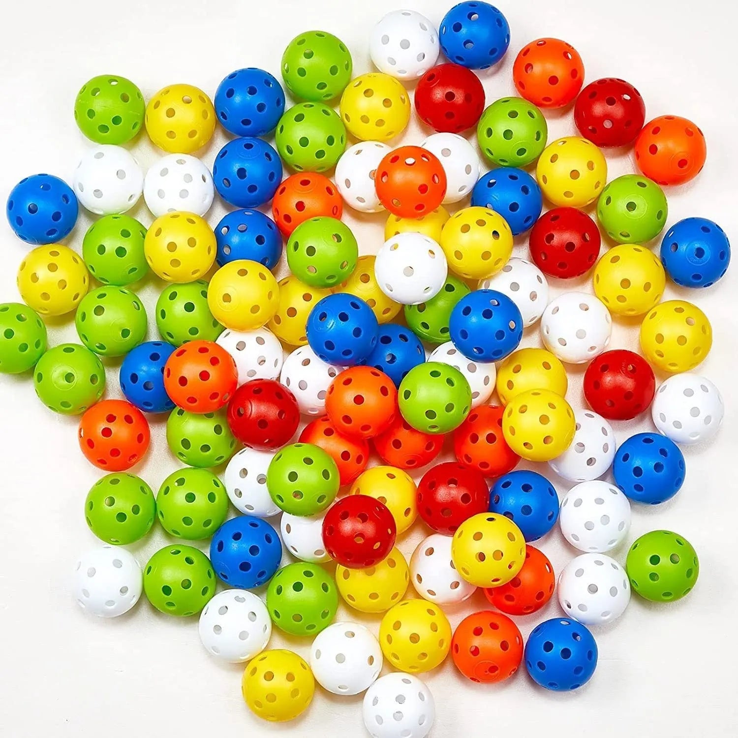 Multi-colour golf practice balls with 26 holes on a green surface.